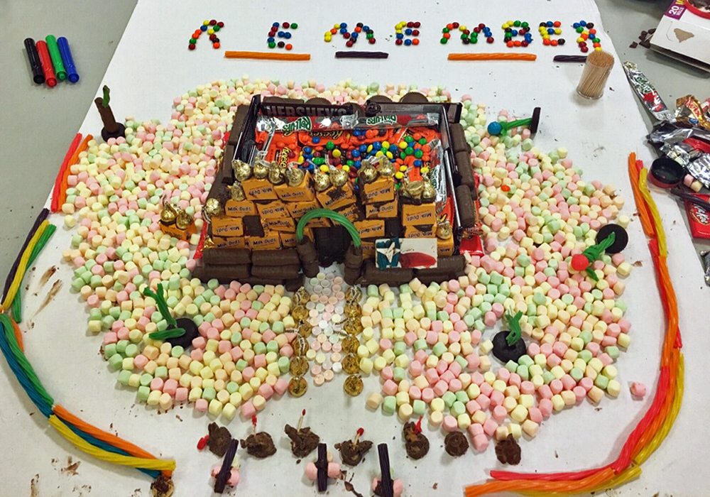 A gingerbread house made out of candies and marshmallows.