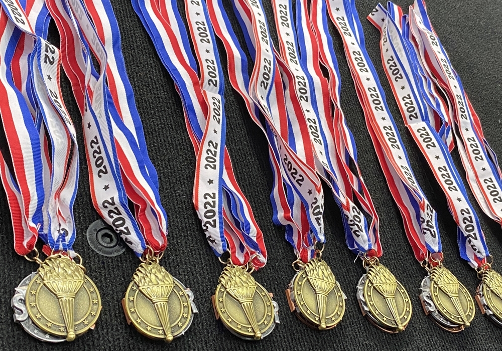 A group of medals with red, white and blue ribbons.