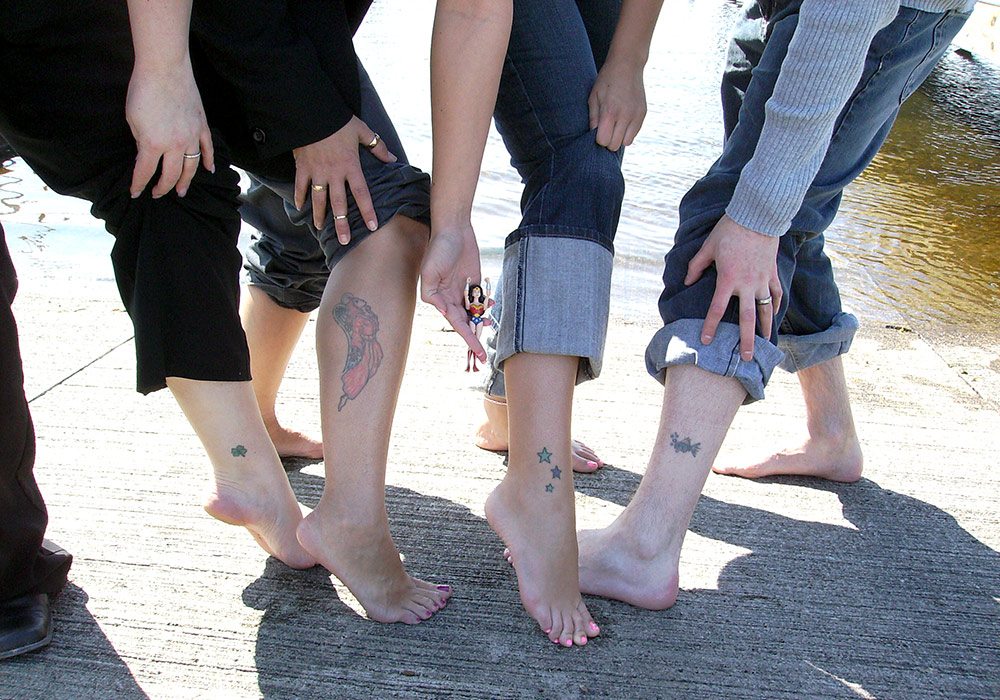 A group of people with tattoos on their feet.