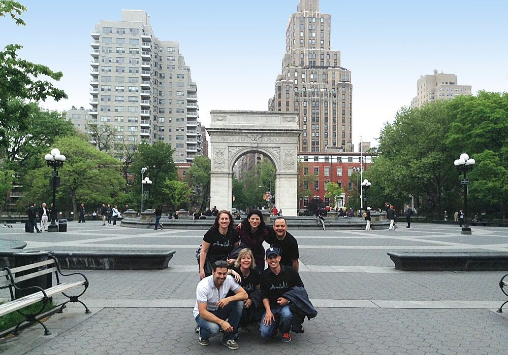 A group of people posing for a photo in a park.