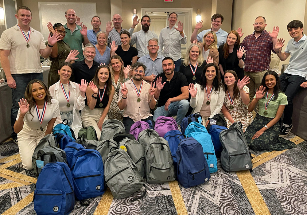 A group of people posing for a photo with backpacks.