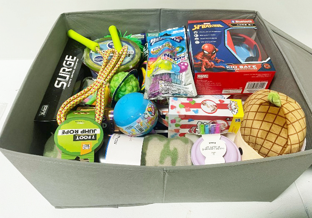 A Toy Donation box filled with toys and other items.
