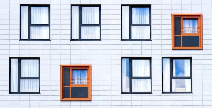 A row of windows on a white building.