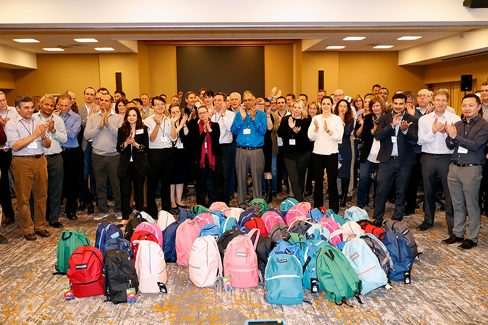 A group of people posing with backpacks.