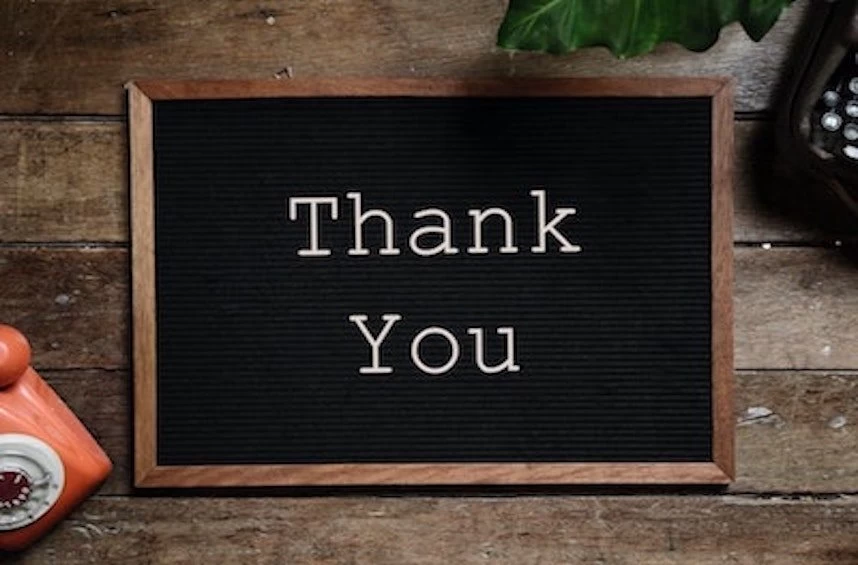 A blackboard with the word thank you next to a telephone, expressing gratitude towards administrative professionals.