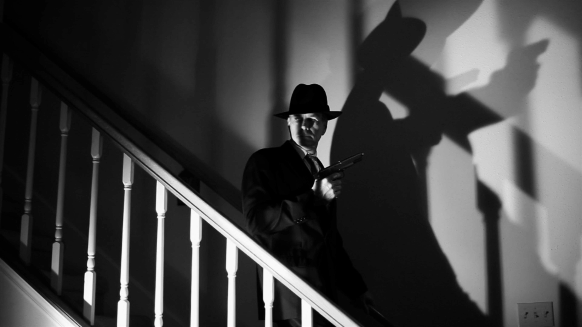 A man in a hat is standing on the stairs.