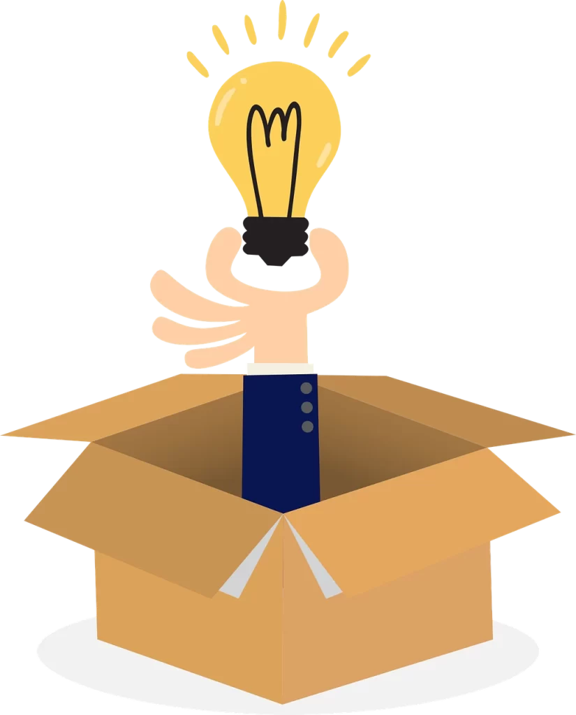 A hand holding a light bulb in a cardboard box.