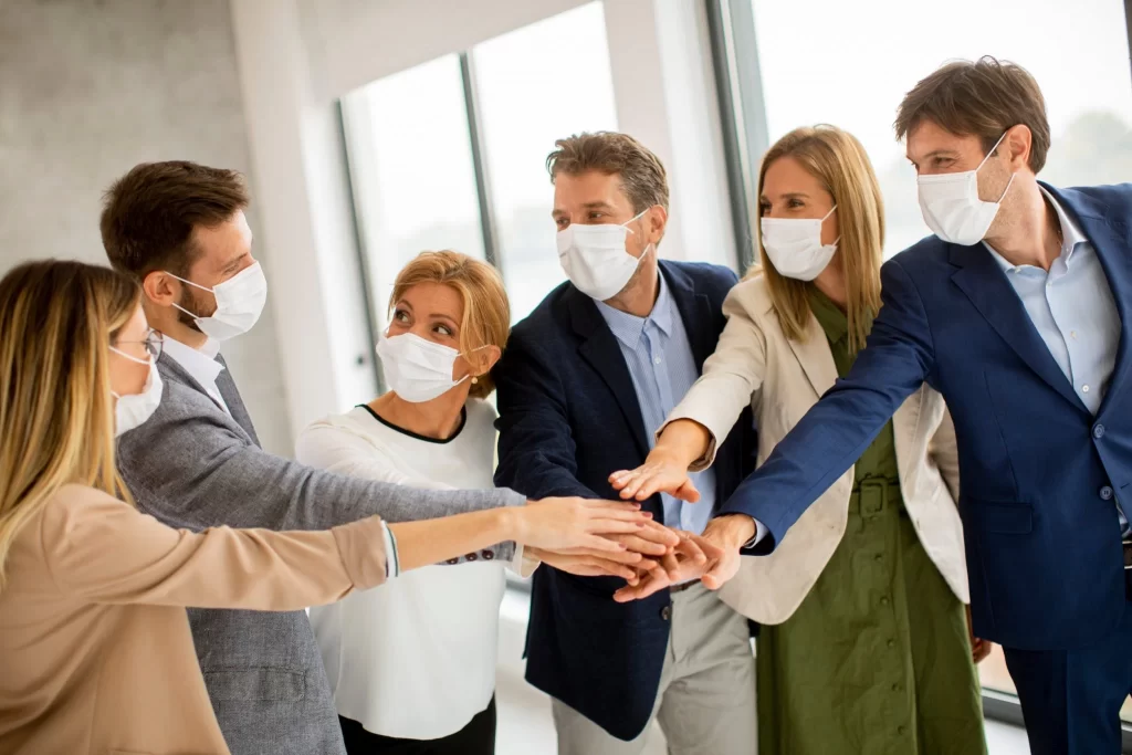 A group of business people wearing surgical masks.