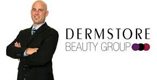 A man in a suit standing in front of a logo for dermstore beauty group.