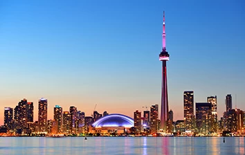 Team building activity in Toronto with the sparkling skyline at dusk and the iconic CN Tower as a breathtaking background.